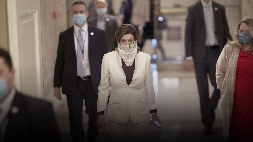 House leader Nancy Pelosi walks the halls of Congress with a face mask and gloves