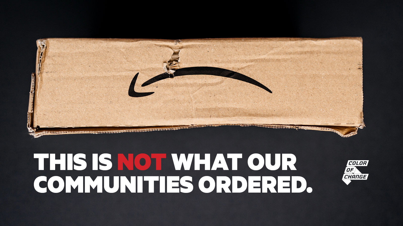 An image of a damaged package with the Amazon logo upside down so it looks like a frown. The text reads 