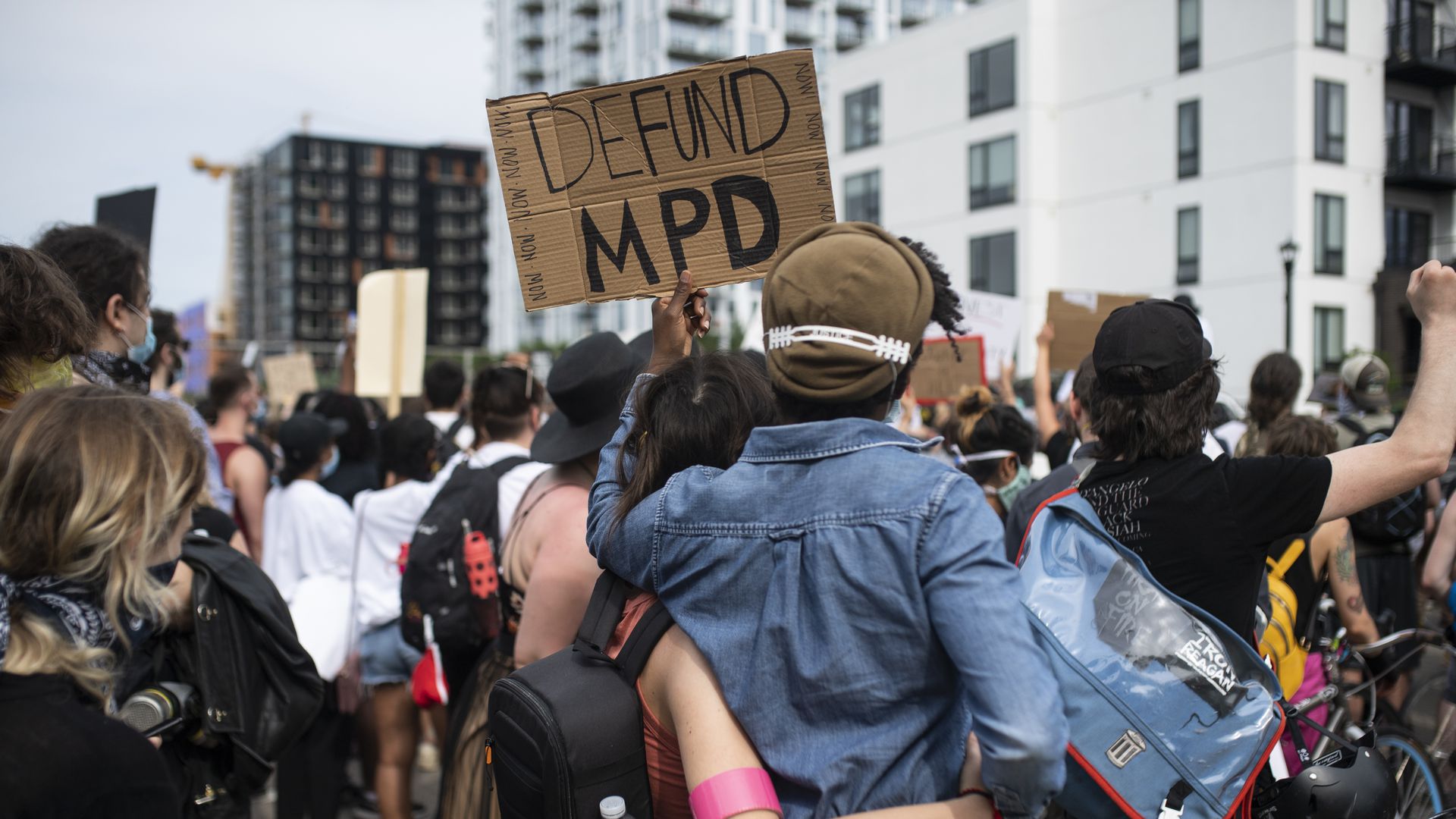 Person holding a sign that reads 