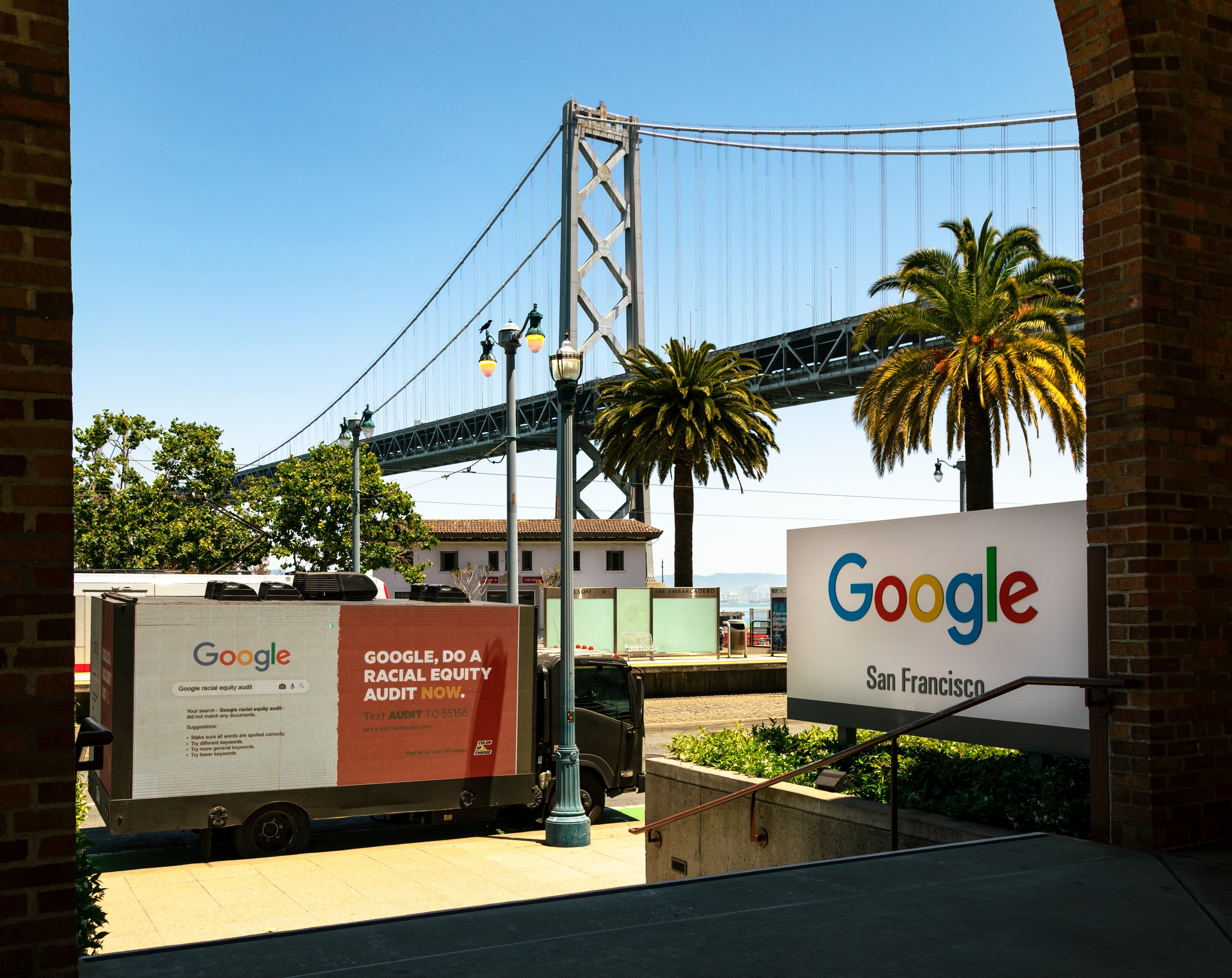 A truck that says "Google, do a racial equity audit now" outside the Google San Francisco office.