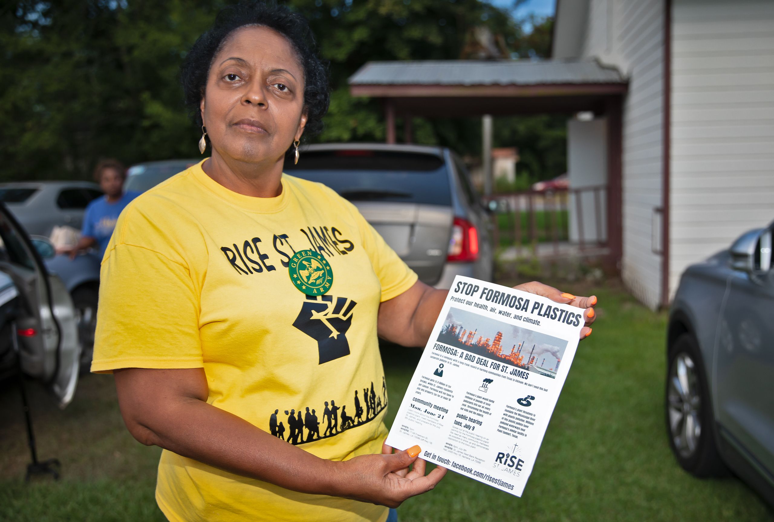 Sharon Lavinge founder of RISE St. James in front of the Mt. Triumph Baptist Church with a flyer about the proposed Formosa plant